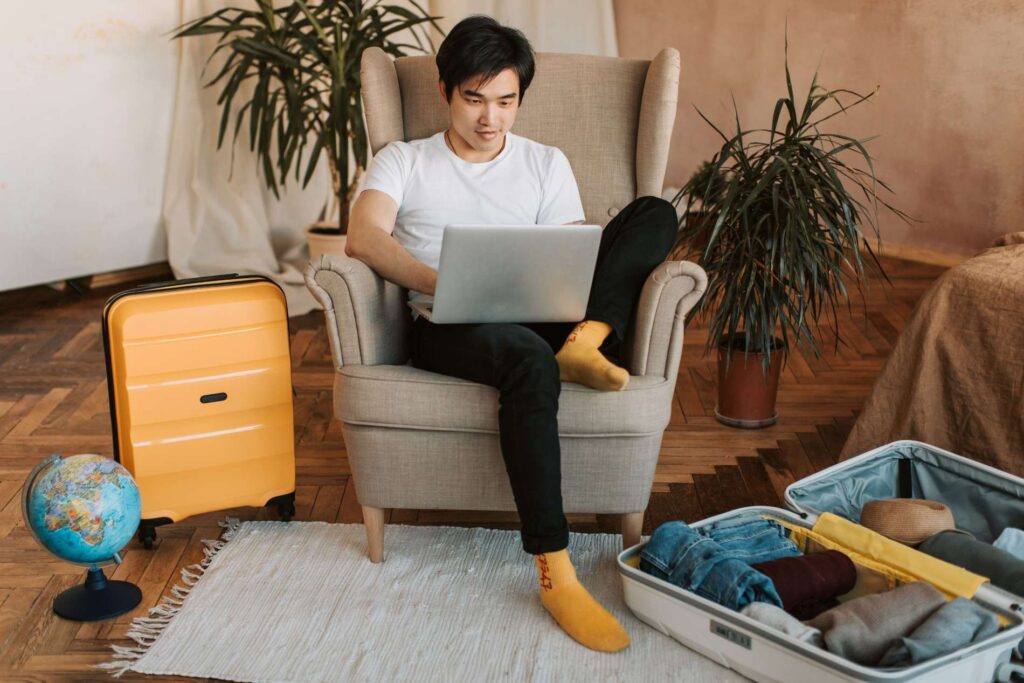 Teacher planning an international move with a laptop and travel documents