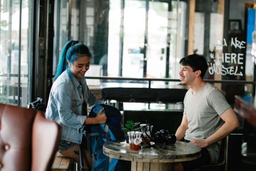 Two travelers meeting and chatting at a cafe while living abroad